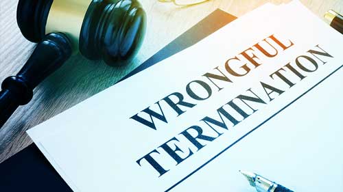 Pile of documents reading 'Wrongful Termination' with a gavel